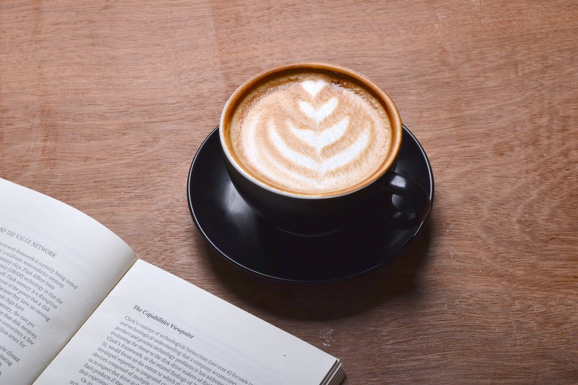 Mug of Coffee Next to Open Book