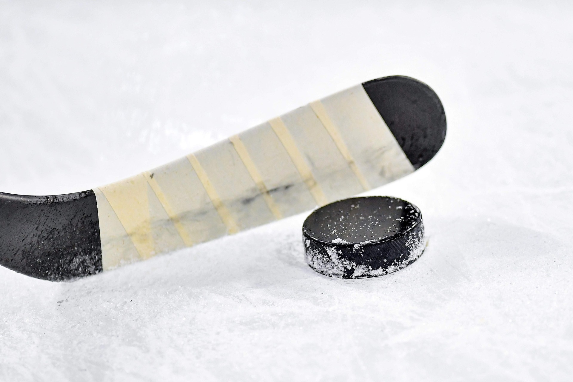 Hockey Stick and Puck on Ice