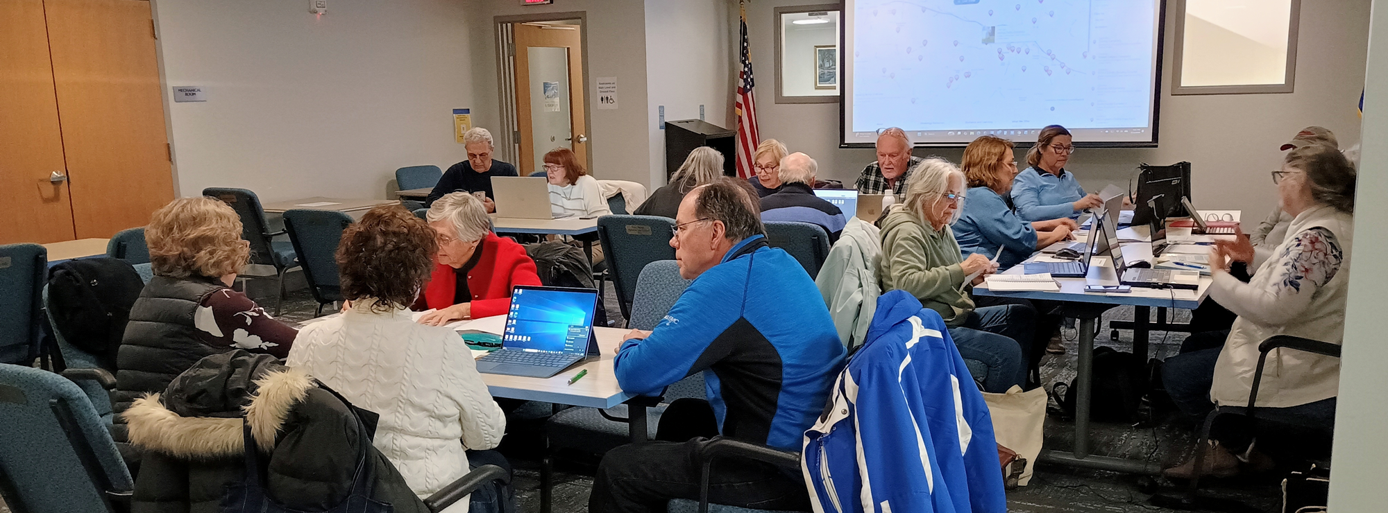 Patrons working on laptops during the DAR Genealogy Workshop in the Meeting Room of the library.