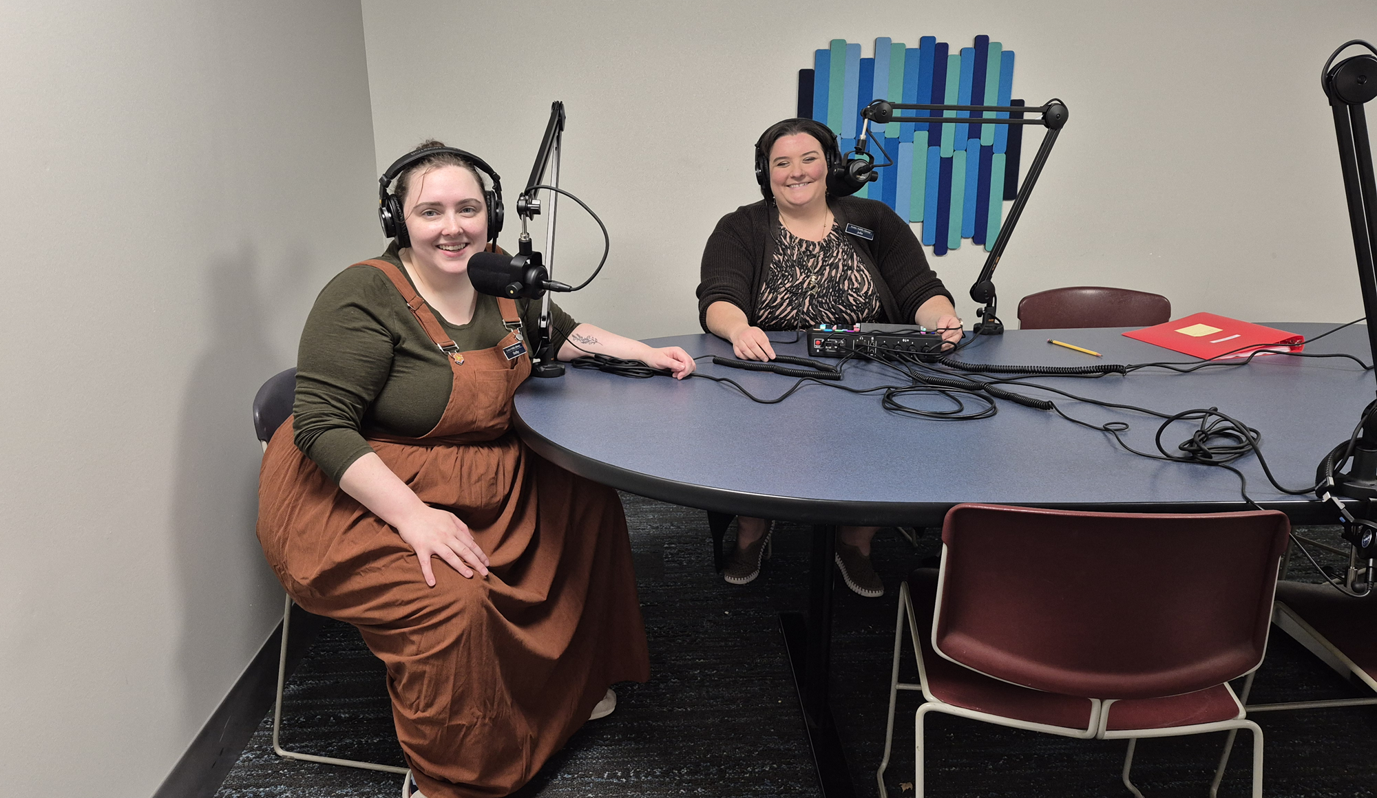 Librarian Shelby and Director Julia testing out the podcast equipment in the Friends Media & Study Room.