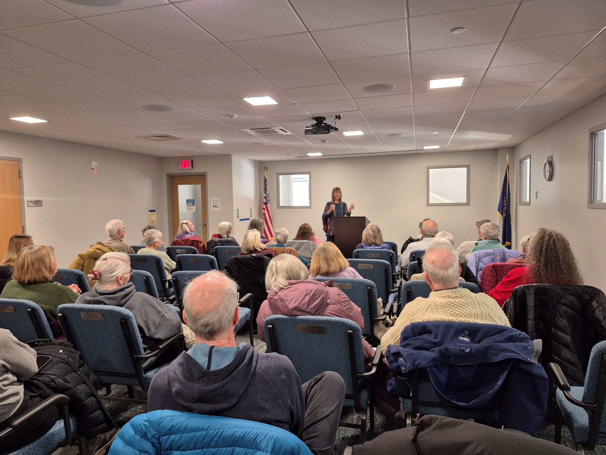 Laura Knoy presenting in the Meeting Room of the library.