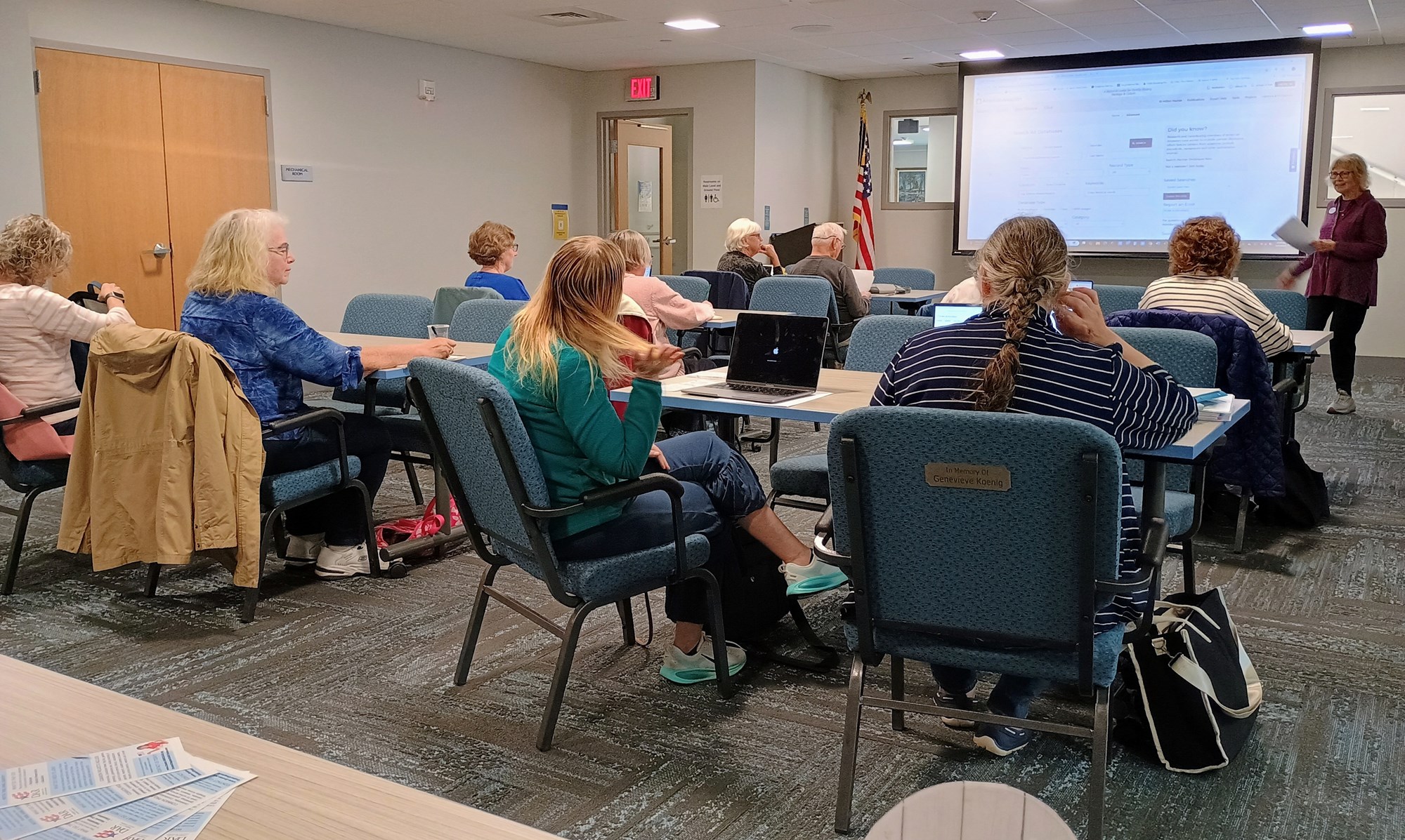 Library visitors working on computers during the genealogy workshop in the Meeting Room of the library.