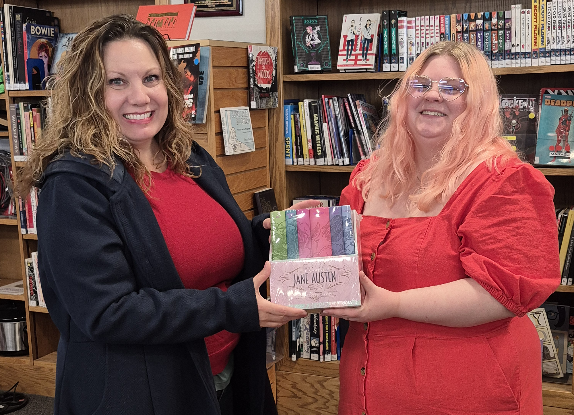 The winner and librarian Loren posing with the set of Jane Austen's books she won.