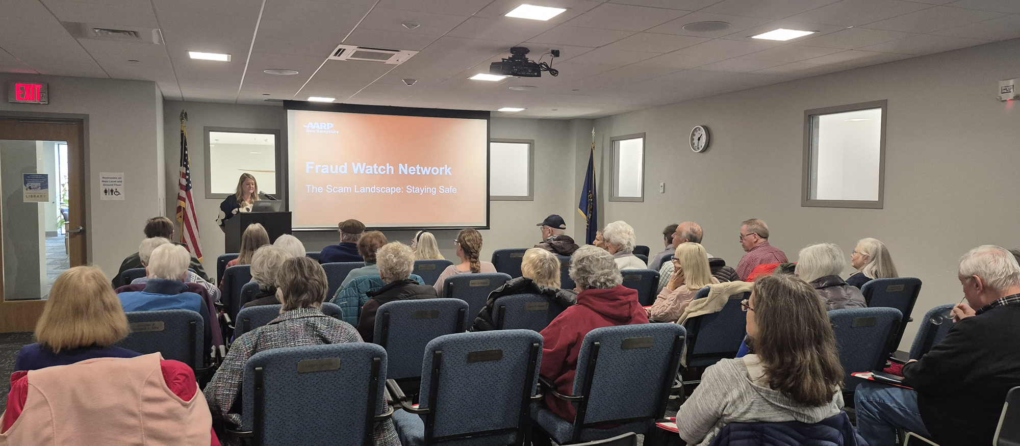 An AARP representative presenting on protecting yourself from scams in the Meeting Room of the library.