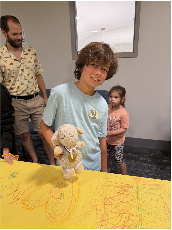 Participant of the 31st annual Stuffed Pet Show with their prize winning lamb
