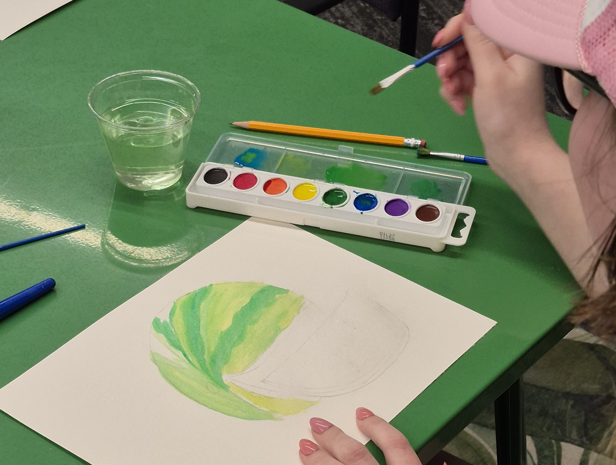 A teen working on a painting.