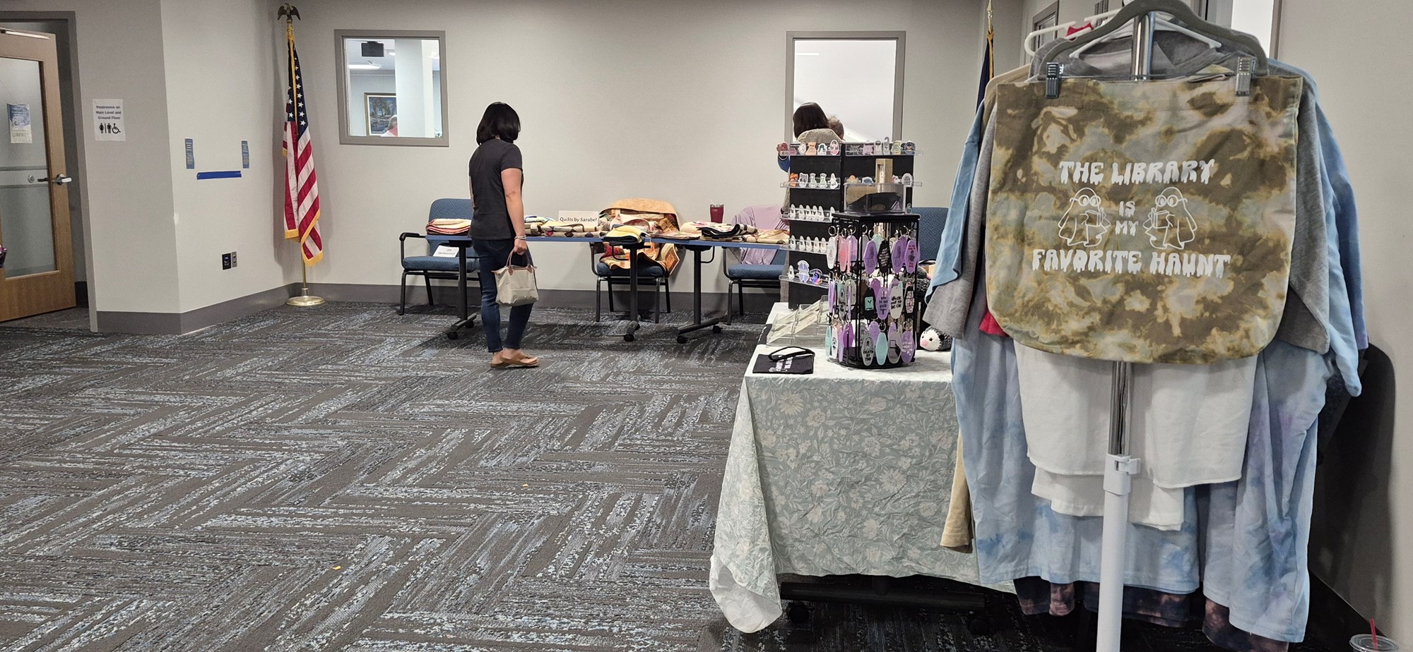 Vendors and a patron in the Meeting Room during the Fall Craft Fair.