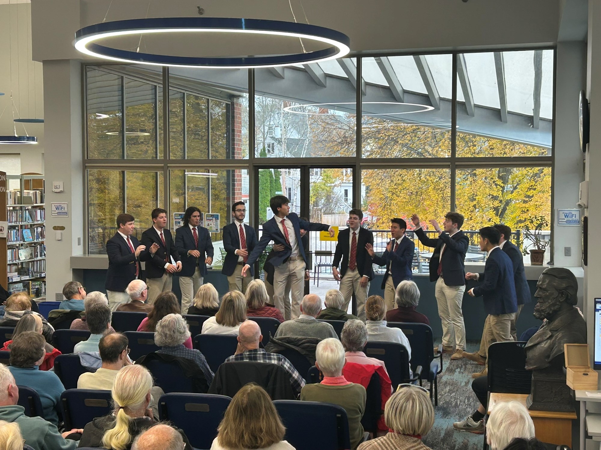 Colgate Thirteen performing in the main seating area of the library.