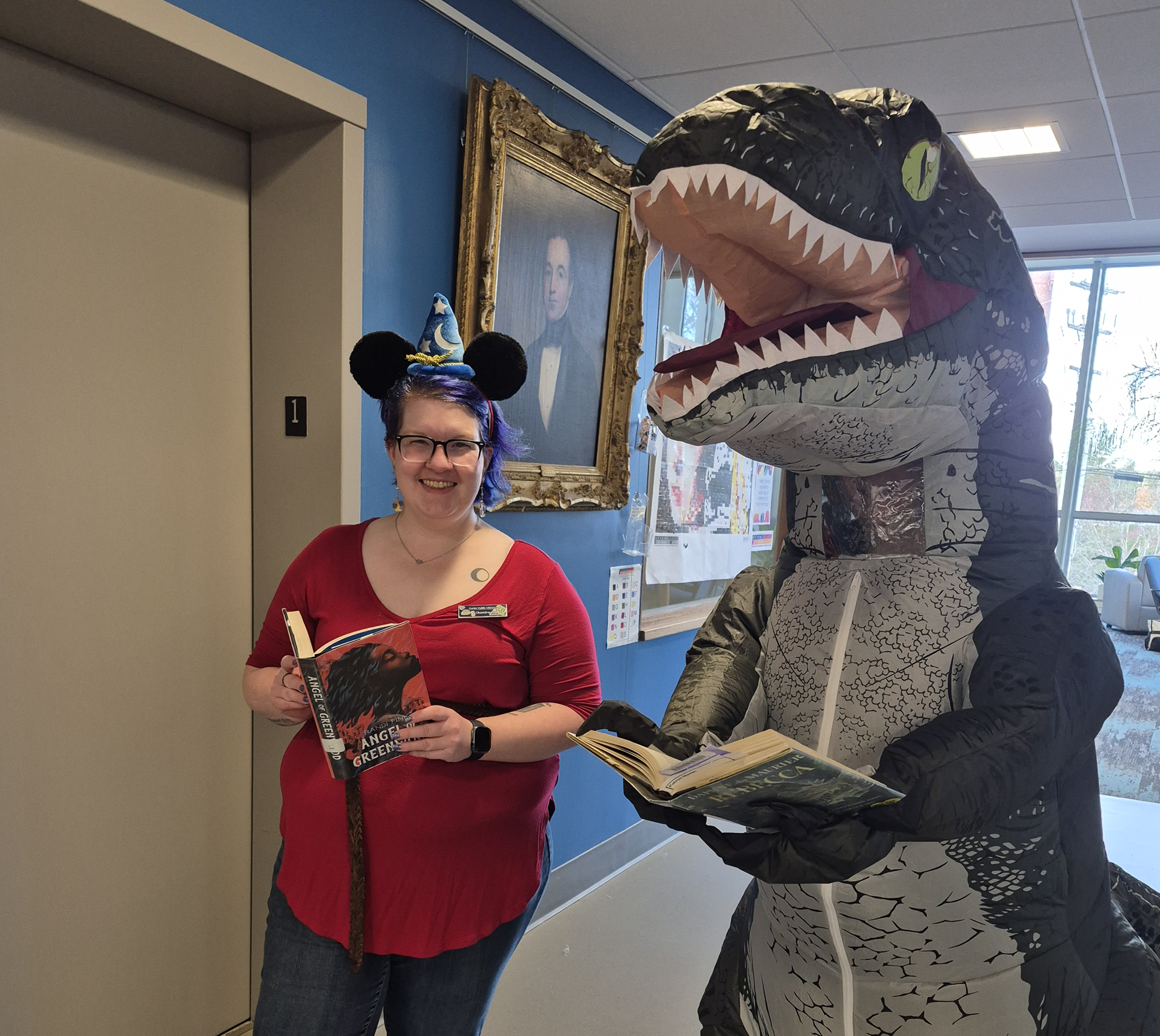 Librarians Chandra and Shelby dressed as a Disney adult and dinosaur