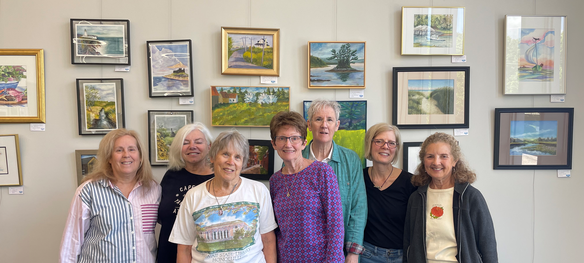 Seacoast Open Studios artists posing in front of their artwork in the Godino Mystery Wing of the library. Seacoast Open Studios artists posing in front of their artwork in the Godino Mystery Wing of the library.