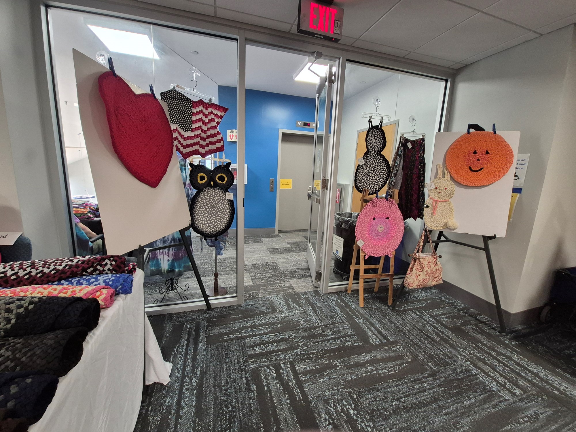 Braided rugs made from recycled denim jeans and T-shirts on display during the Craft Fair on the mezzanine floor of the library