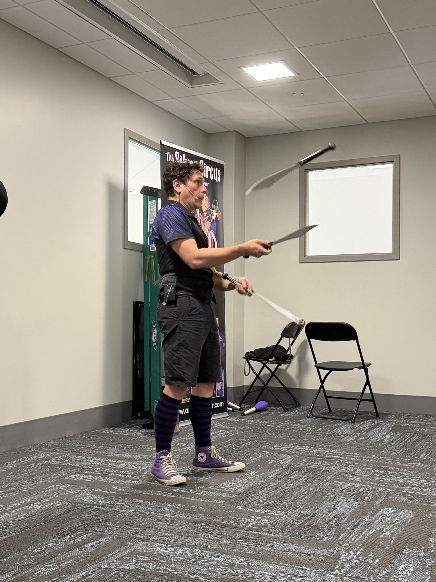 A member of Silver Circus Variety Show juggling in the Meeting Room.