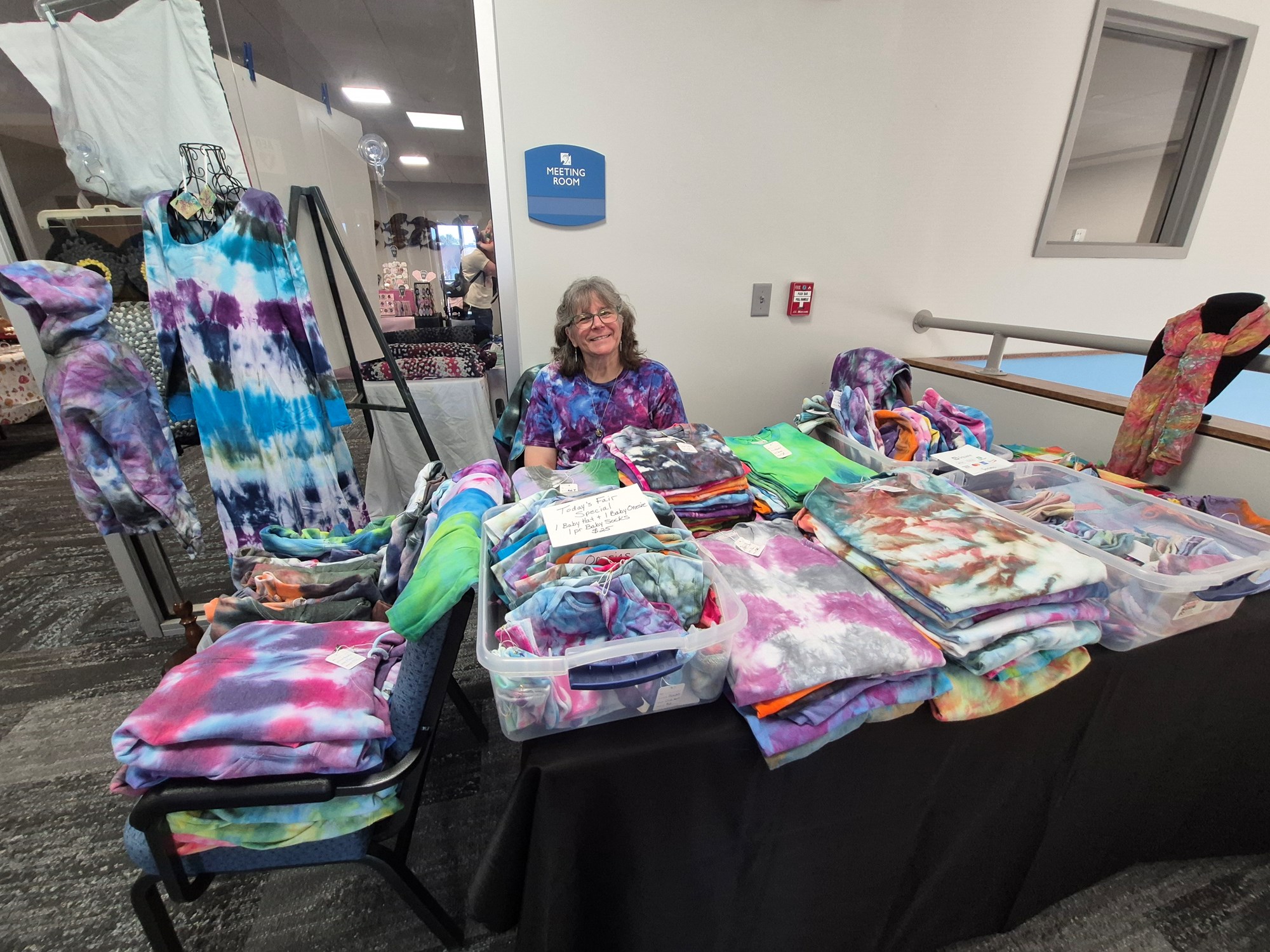 Vendor selling tie-dye items on the mezzanine floor of the library