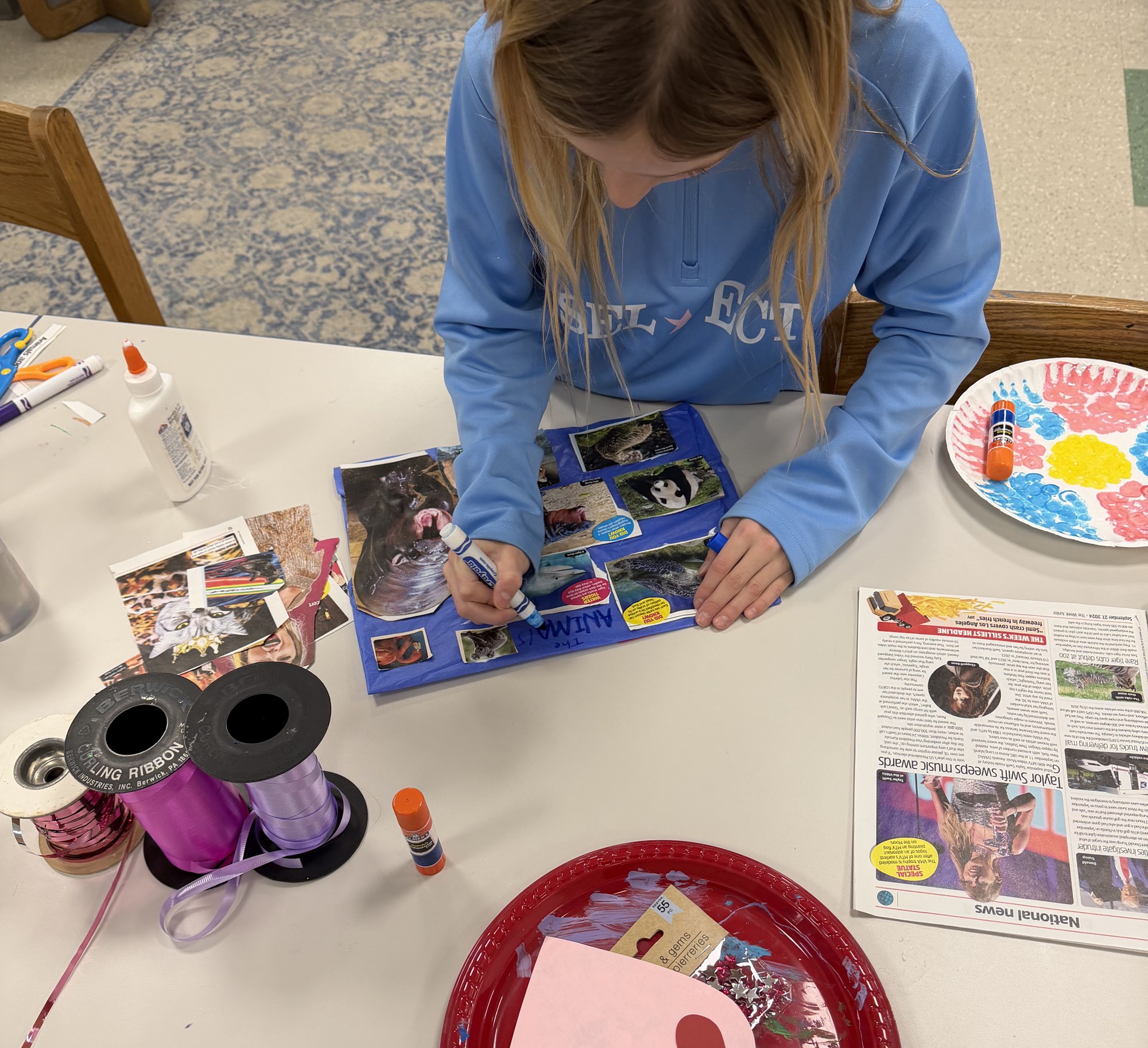 Art Club member making a collage in the Art Room.