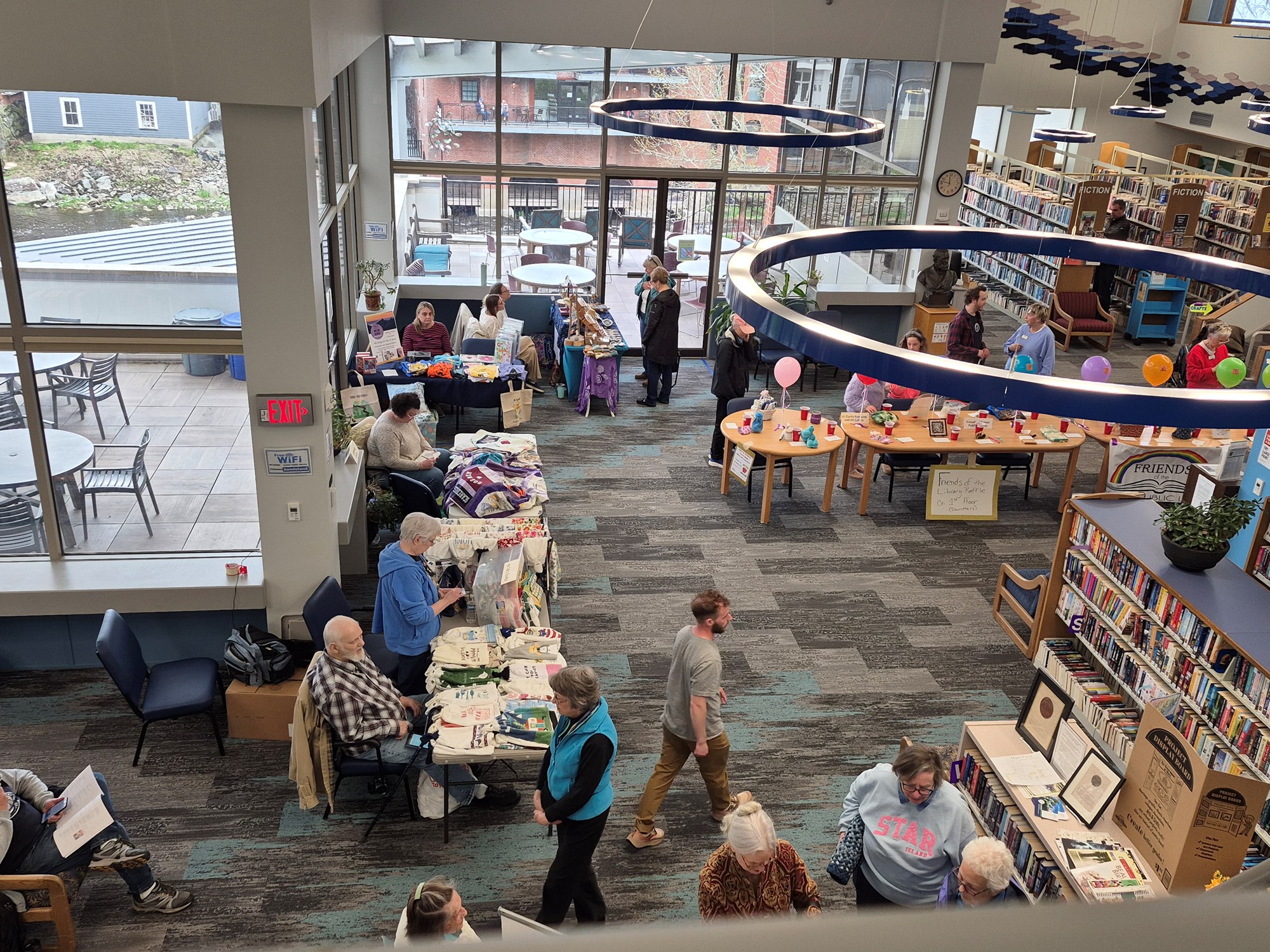 Vendors and patrons at the Spring Craft Fair in the Main Seating area of the library.