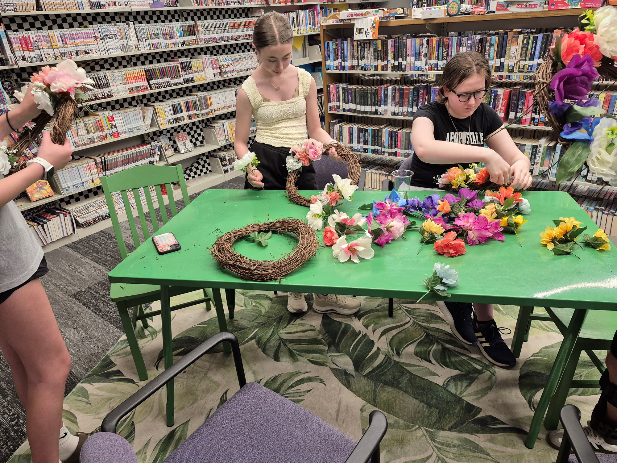 Teens working on their flower wreaths in the Teen Scene.