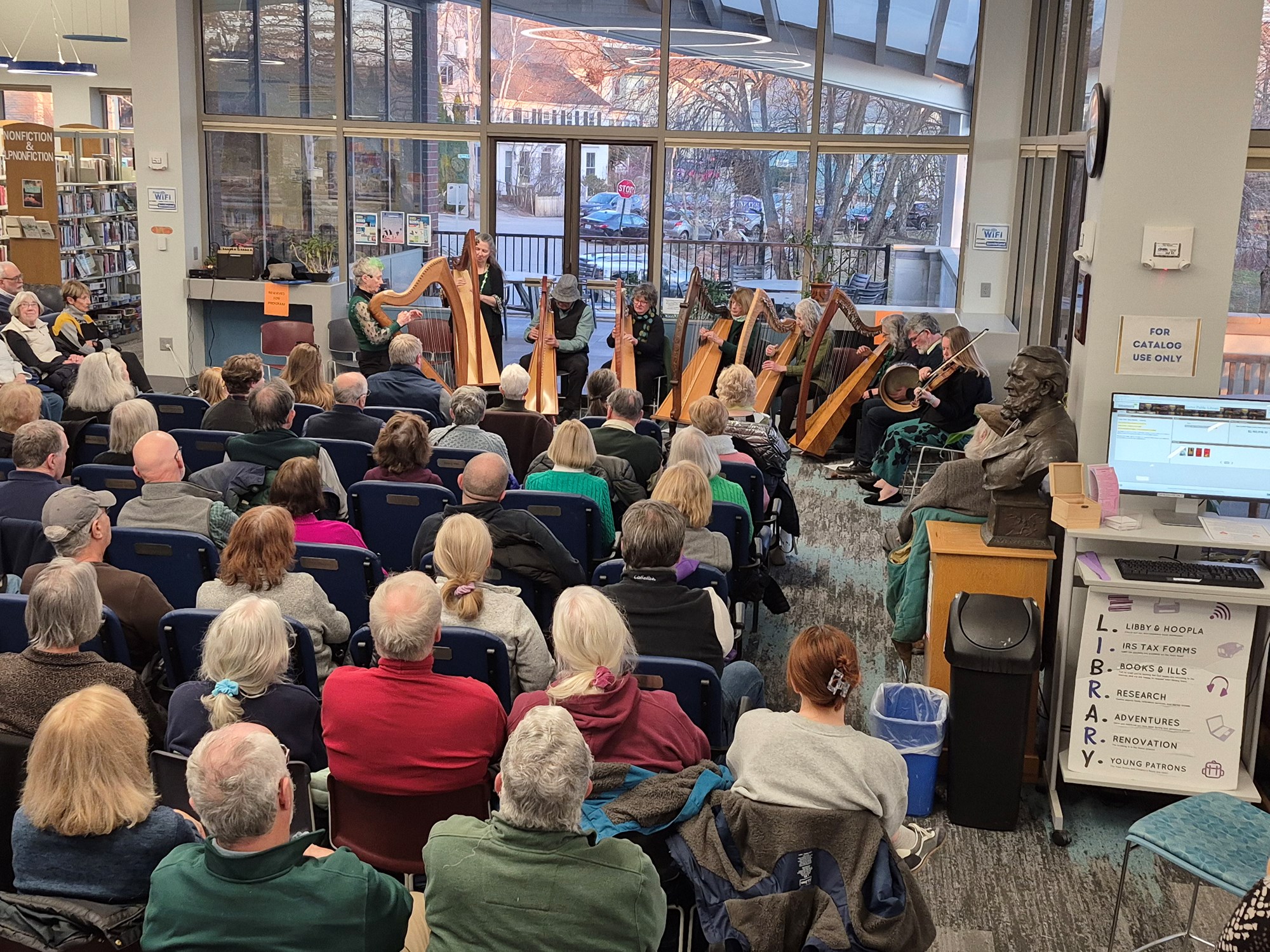 The New England Irish Orchestra performing on the main floor of the library.