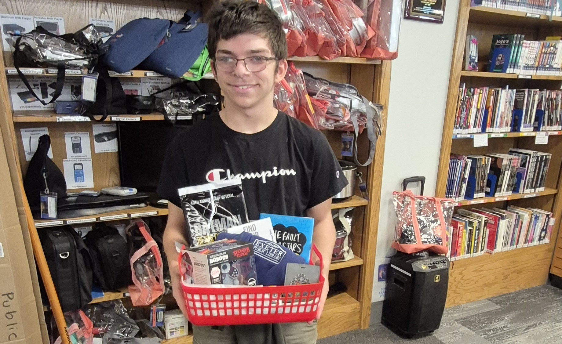 The winner of the Teen Takeover raffle posing with their prize.