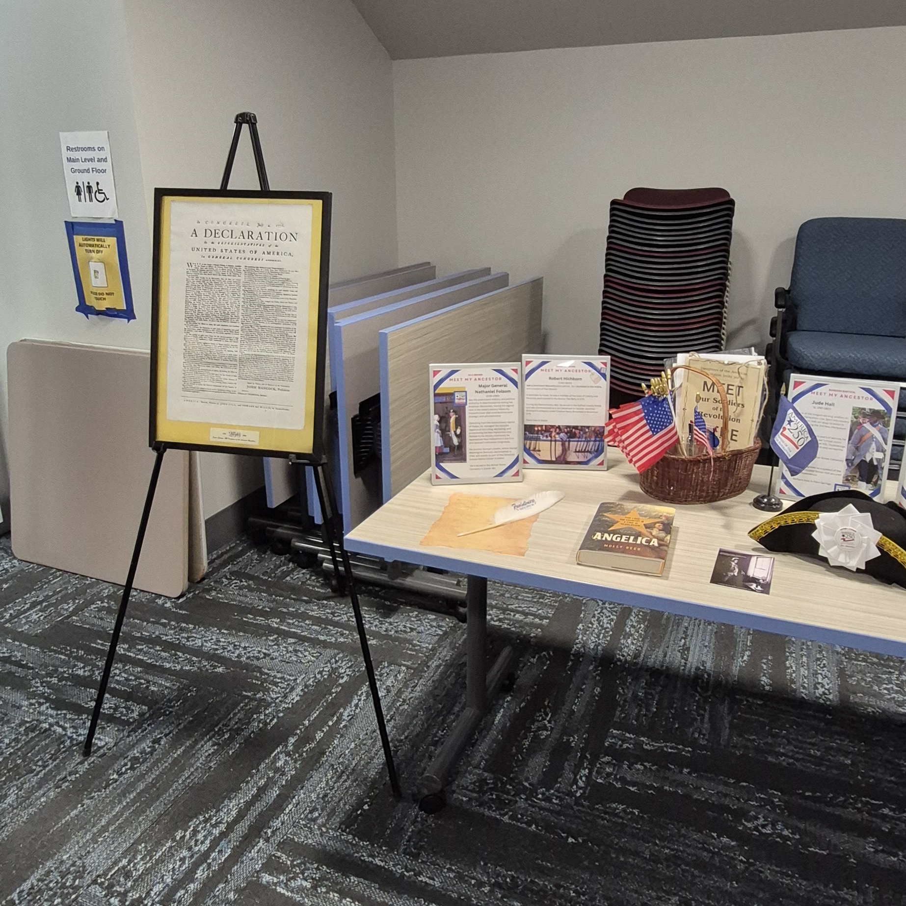 A copy of the Declaration of Independence and other American Revolution information on display on a table in the Meeting Room of the library.