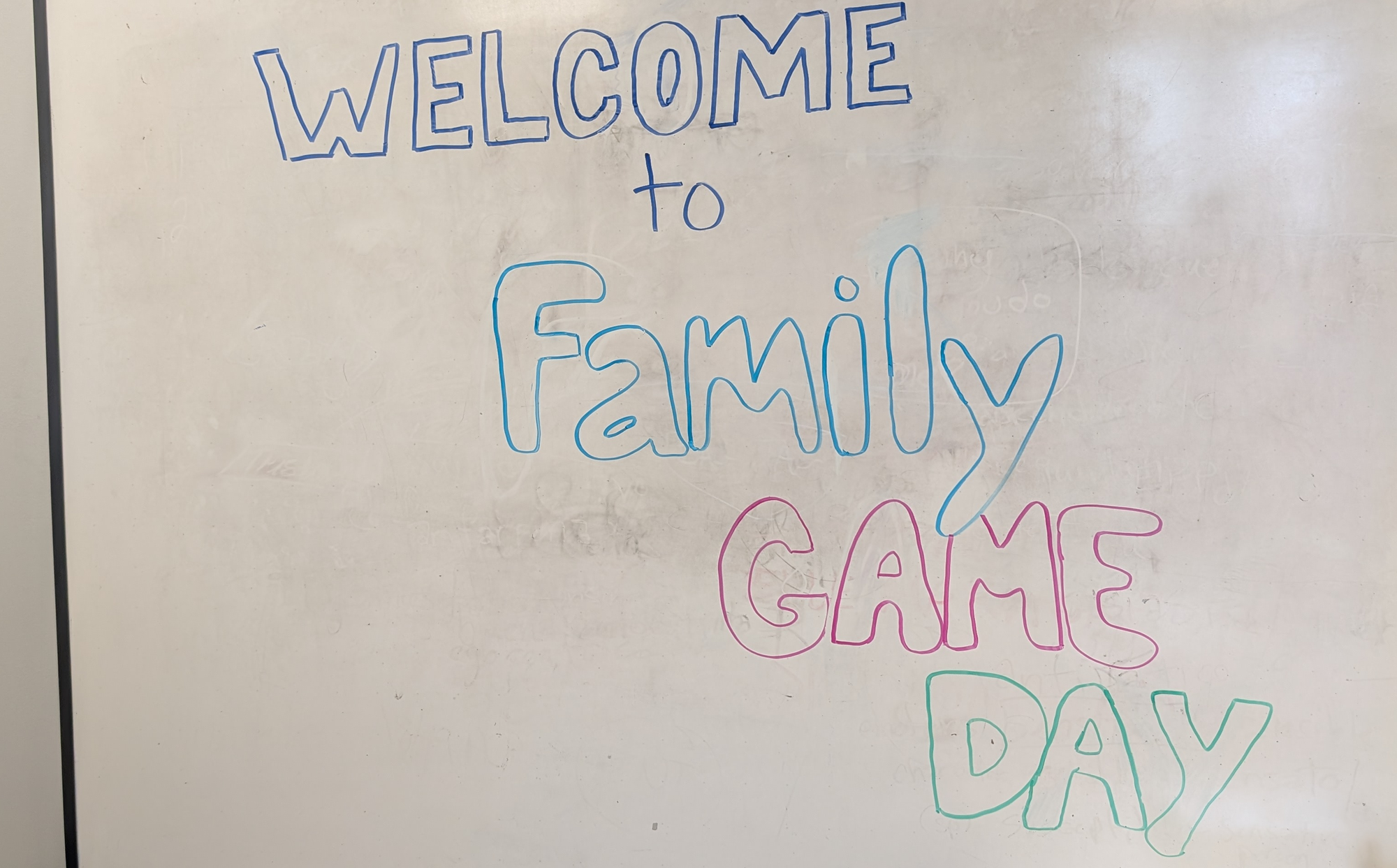 Welcome to Family Game Day written on a whiteboard.