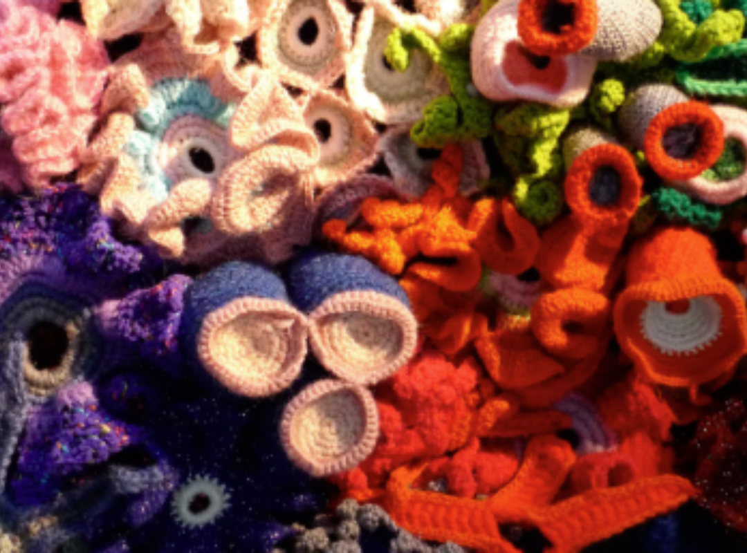 Photograph of various colored yarn stacked on top of one another