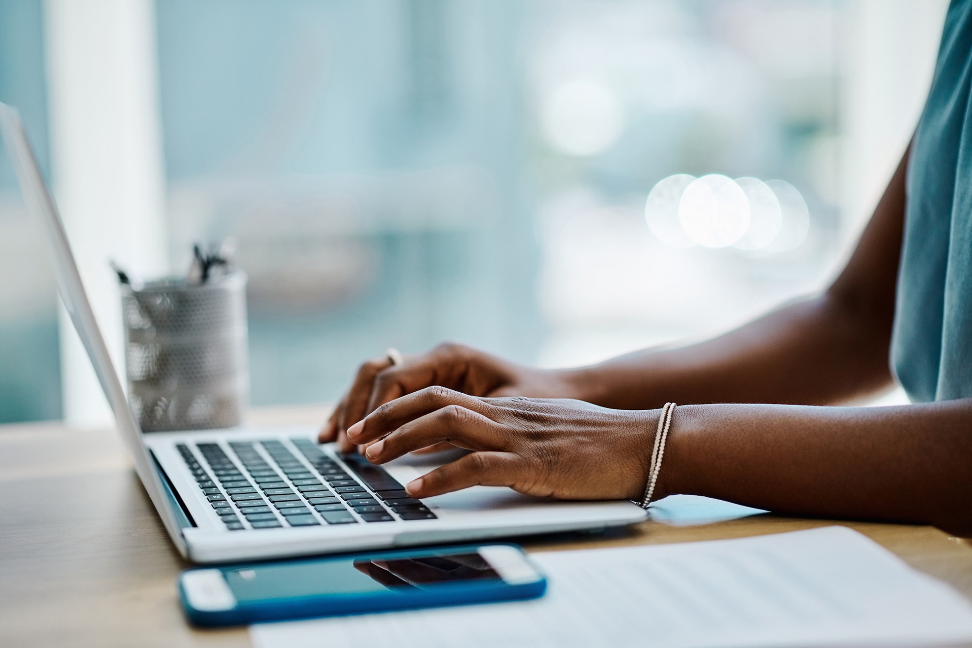 Close-up of a Business Woman Typing on a Laptop Keyboard