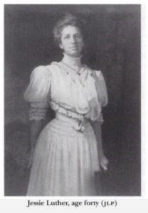 black and white photo of a woman in Victorian era dress