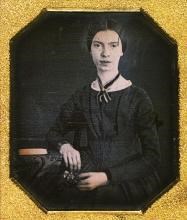 sepia photo of a young woman with dark hair and dress