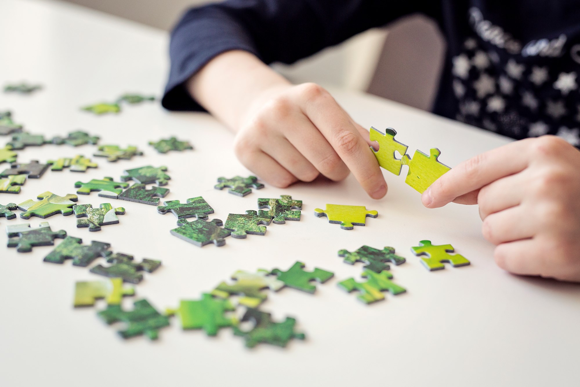 Child Putting Jigsaw Puzzle Together