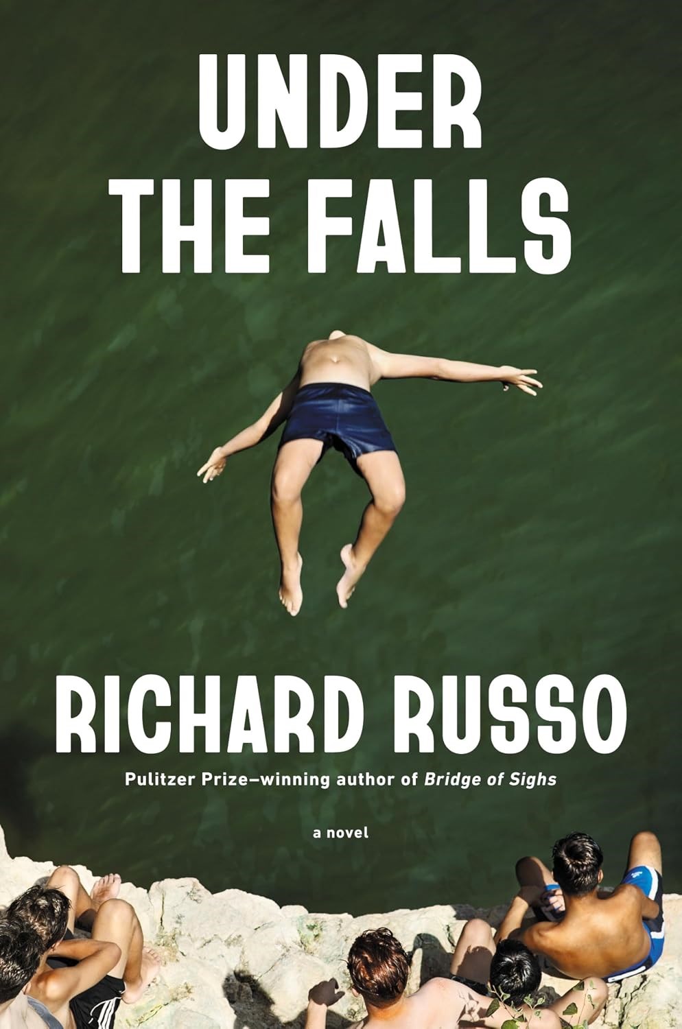 white man backflipping off a rock into water