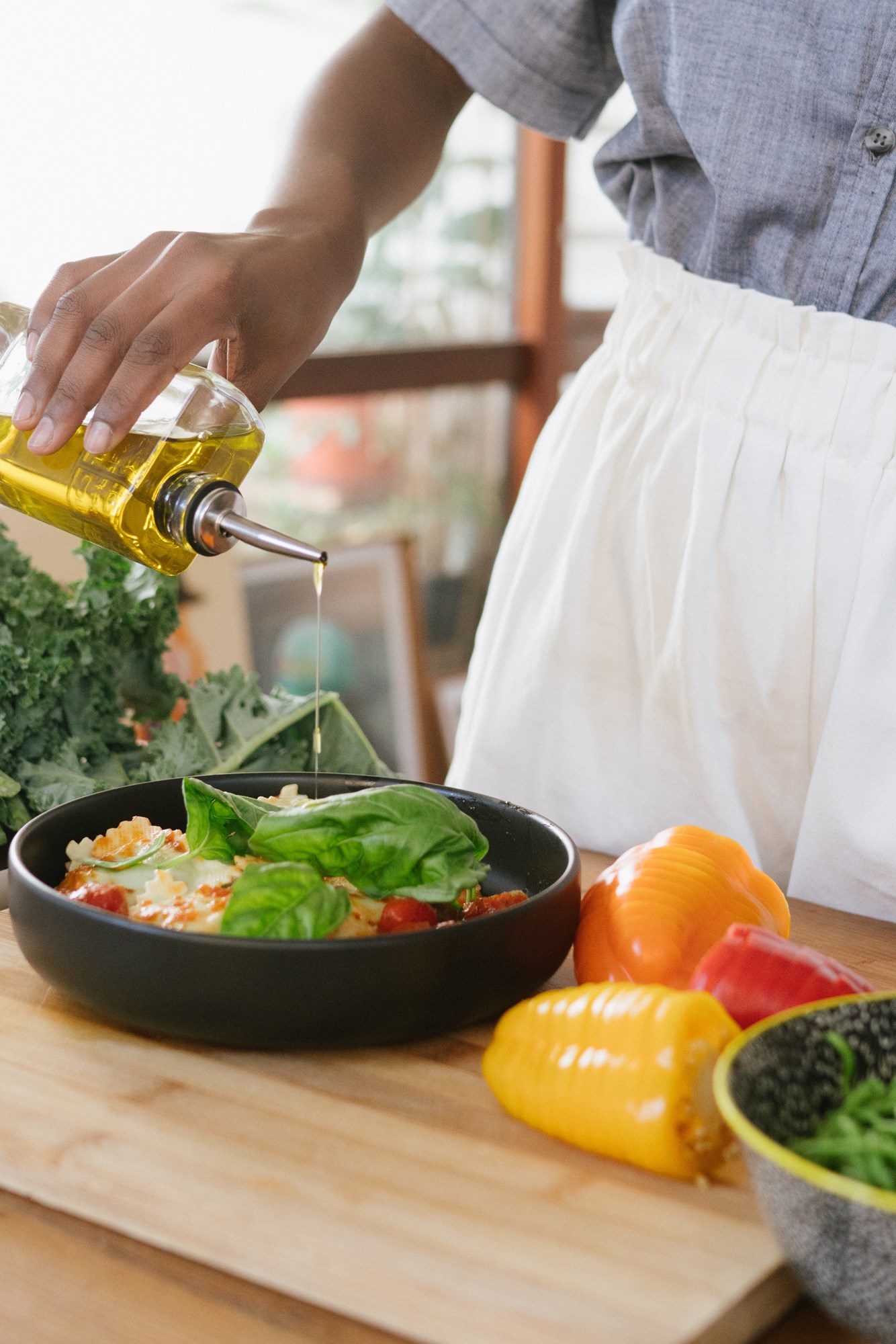 Woman Drizzling Oil Over her Food
