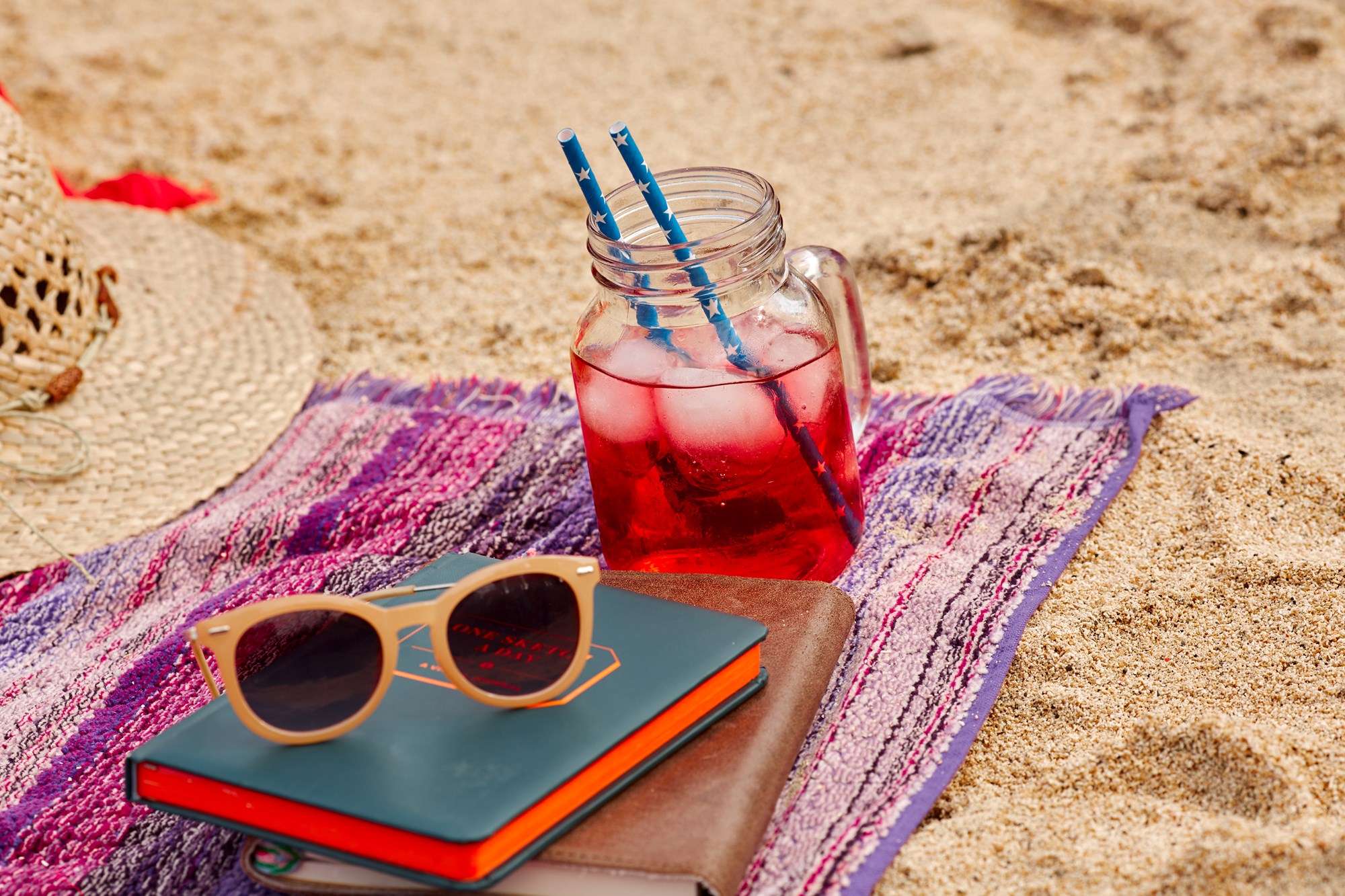 Fresh Made Drink Sunglasses And Book On Beach Towel