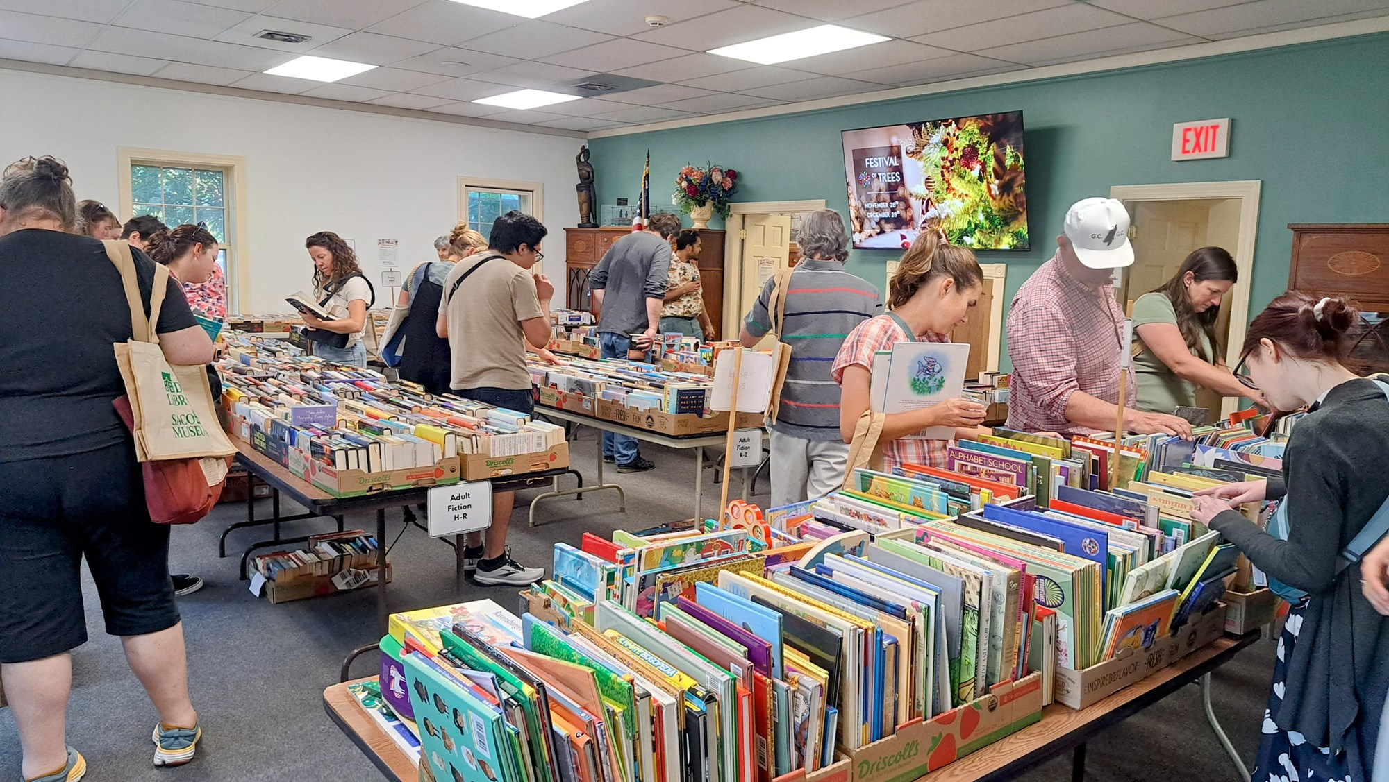 people looking at tables of books