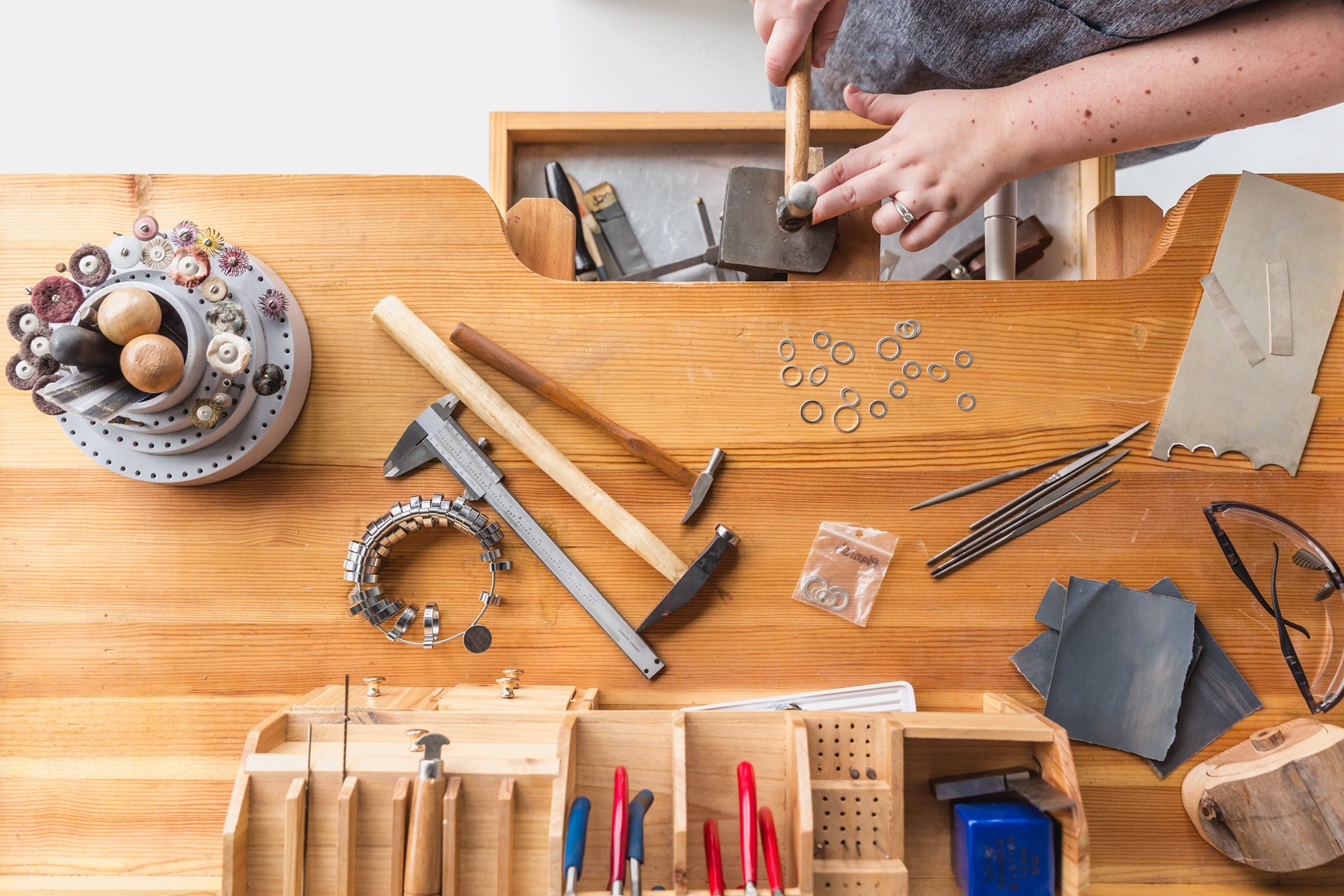 Jeweler Working on a Wooden Table