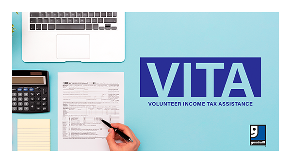 Computer, calculator, notepad a person’s hand holding a pen and a 2023 1040 tax form. Goodwill logo. Text image, ‘VITA VOLUNTEER INCOME TAX ASSISTANCE’