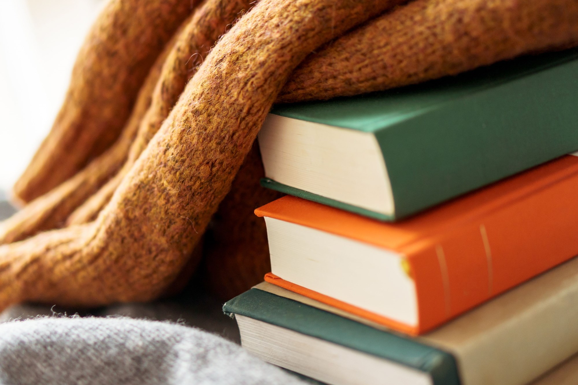 Colorful Books Stacked with Cozy Wool Blanket