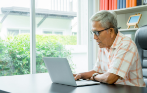 Senior Woman Holding Debit Card and Laptop to do Online Transaction.jpeg