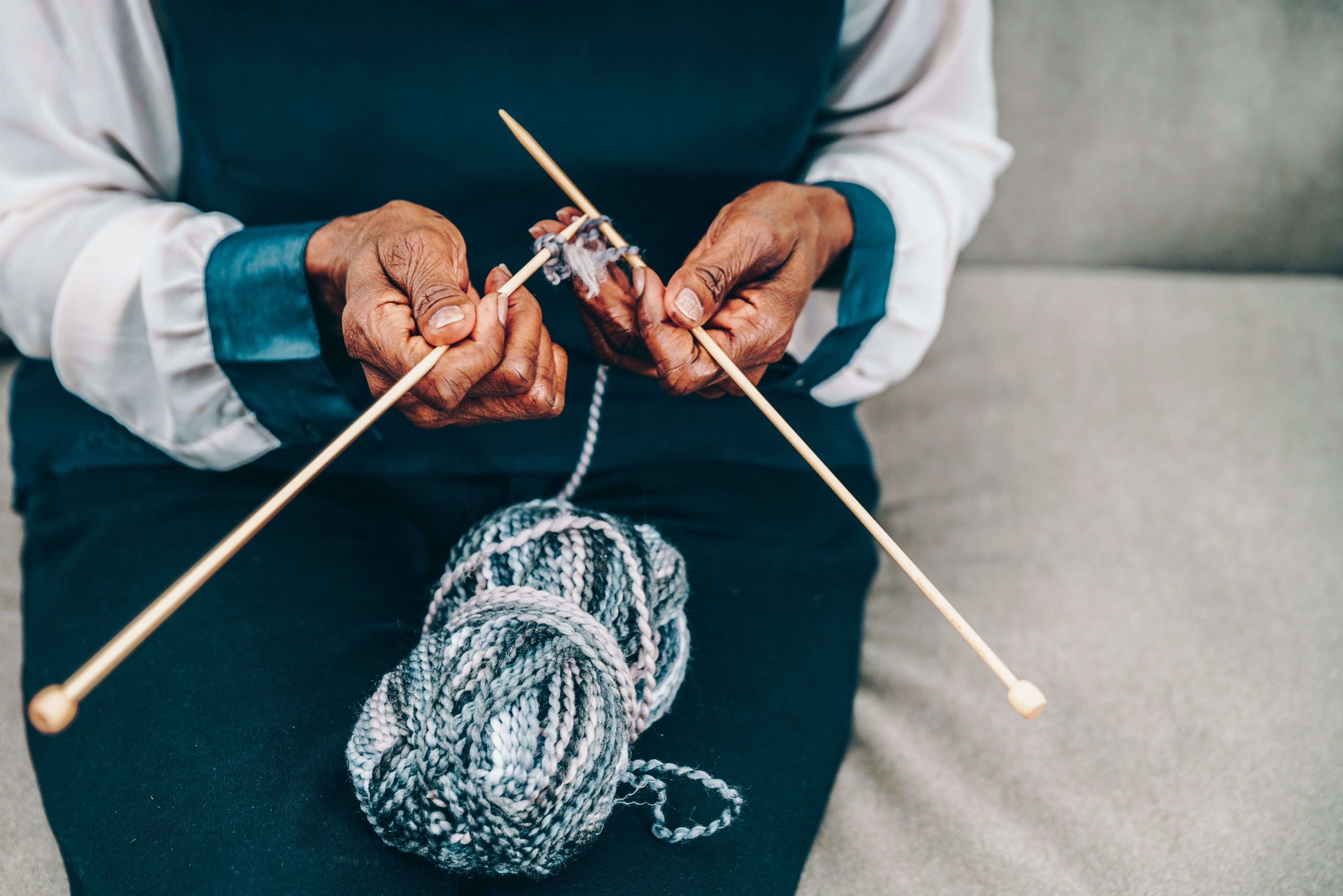 Woman Knitting on a Sofa