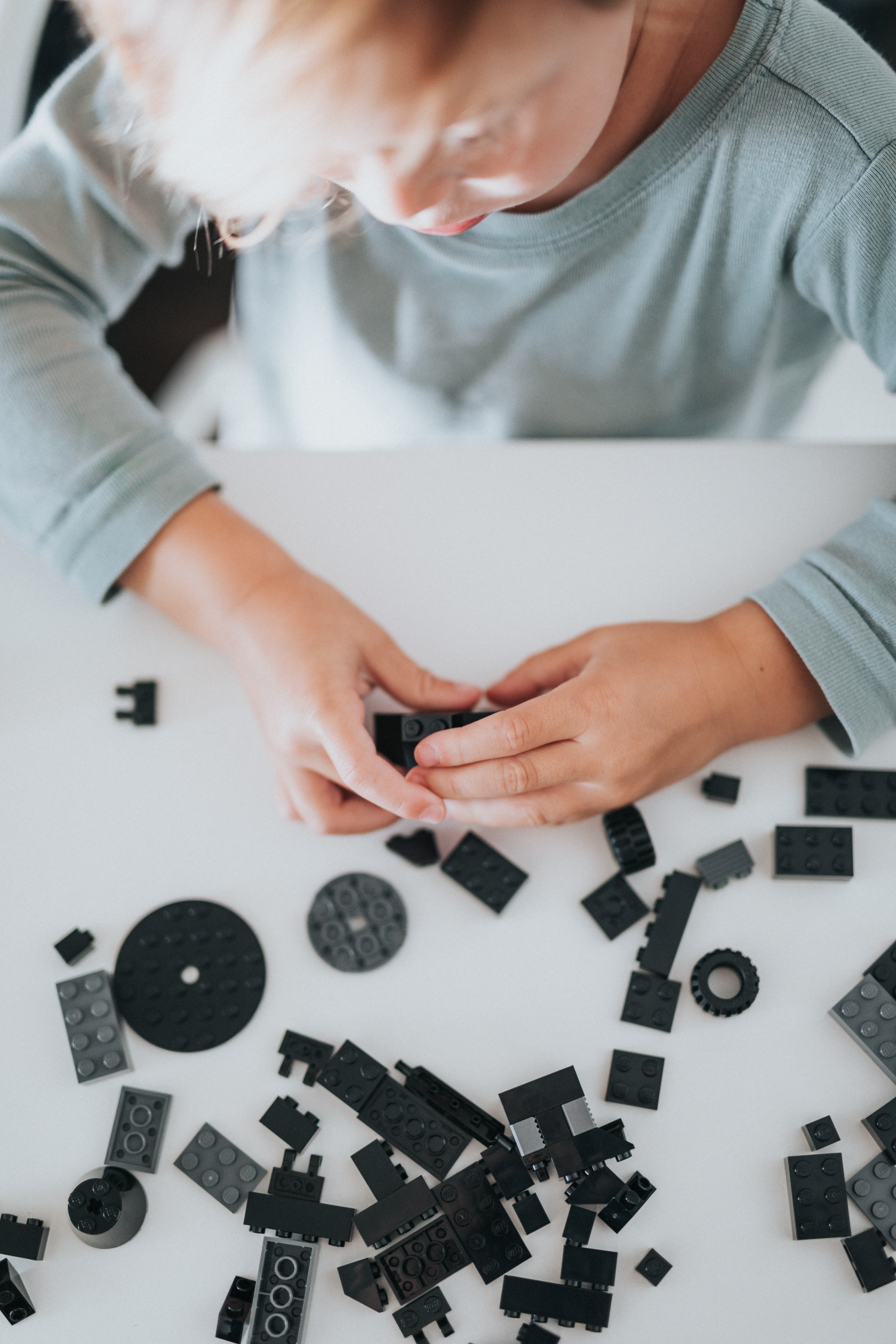 Child Building with Black Blocks