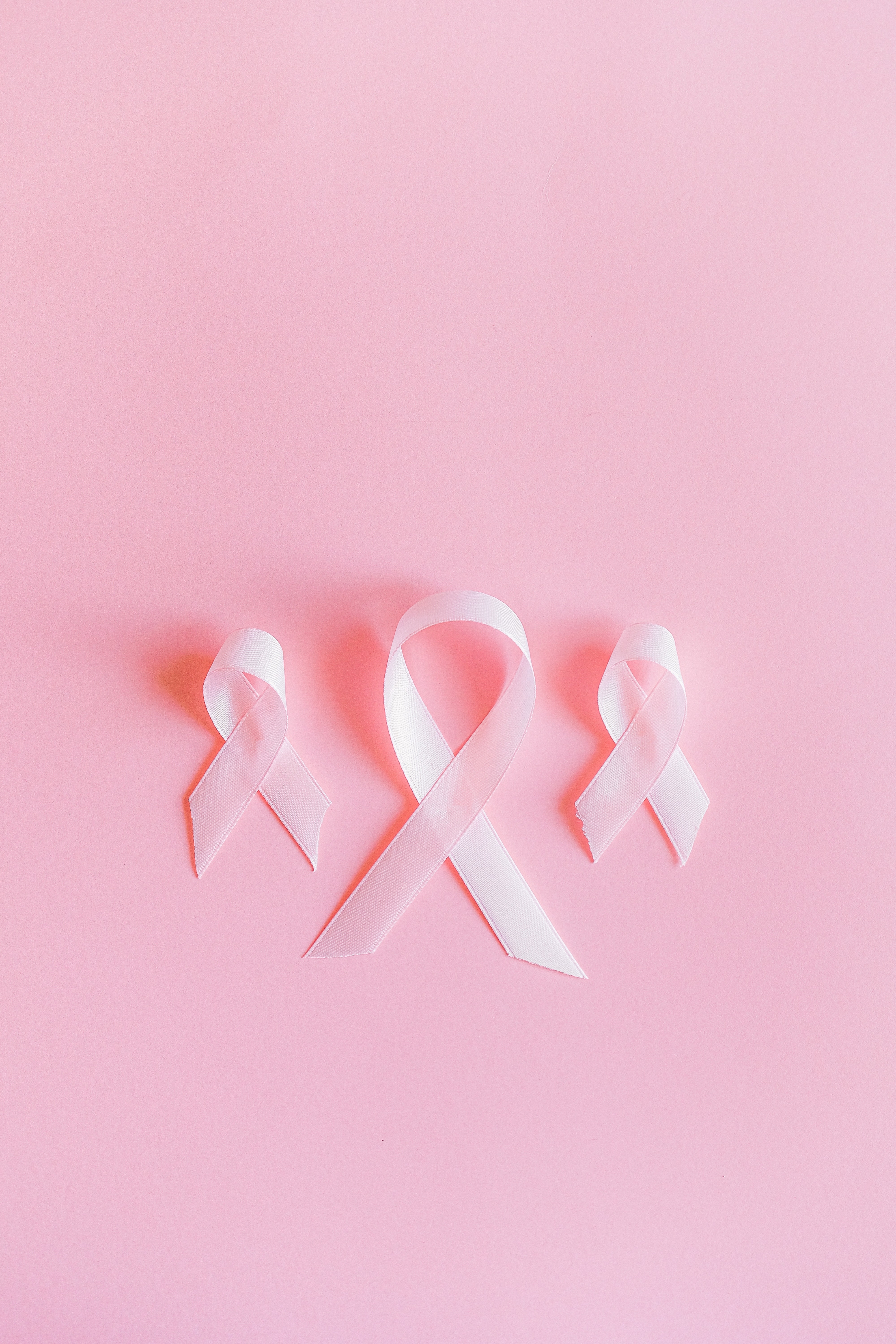 Three Pink Ribbons on Pink Background
