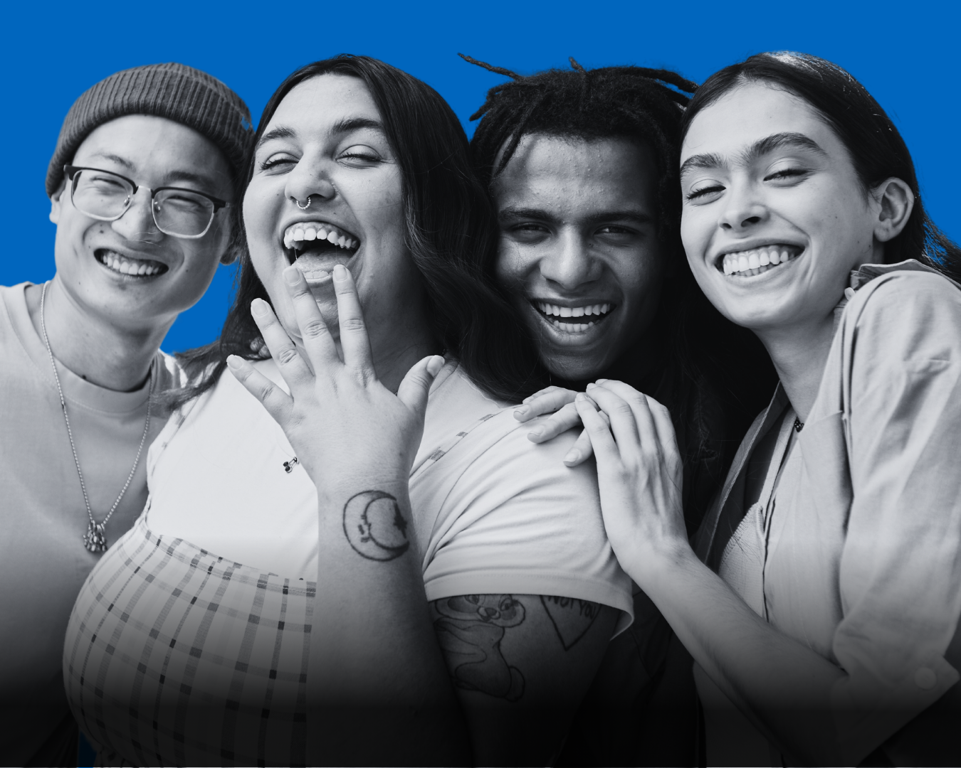 Four adults laughing