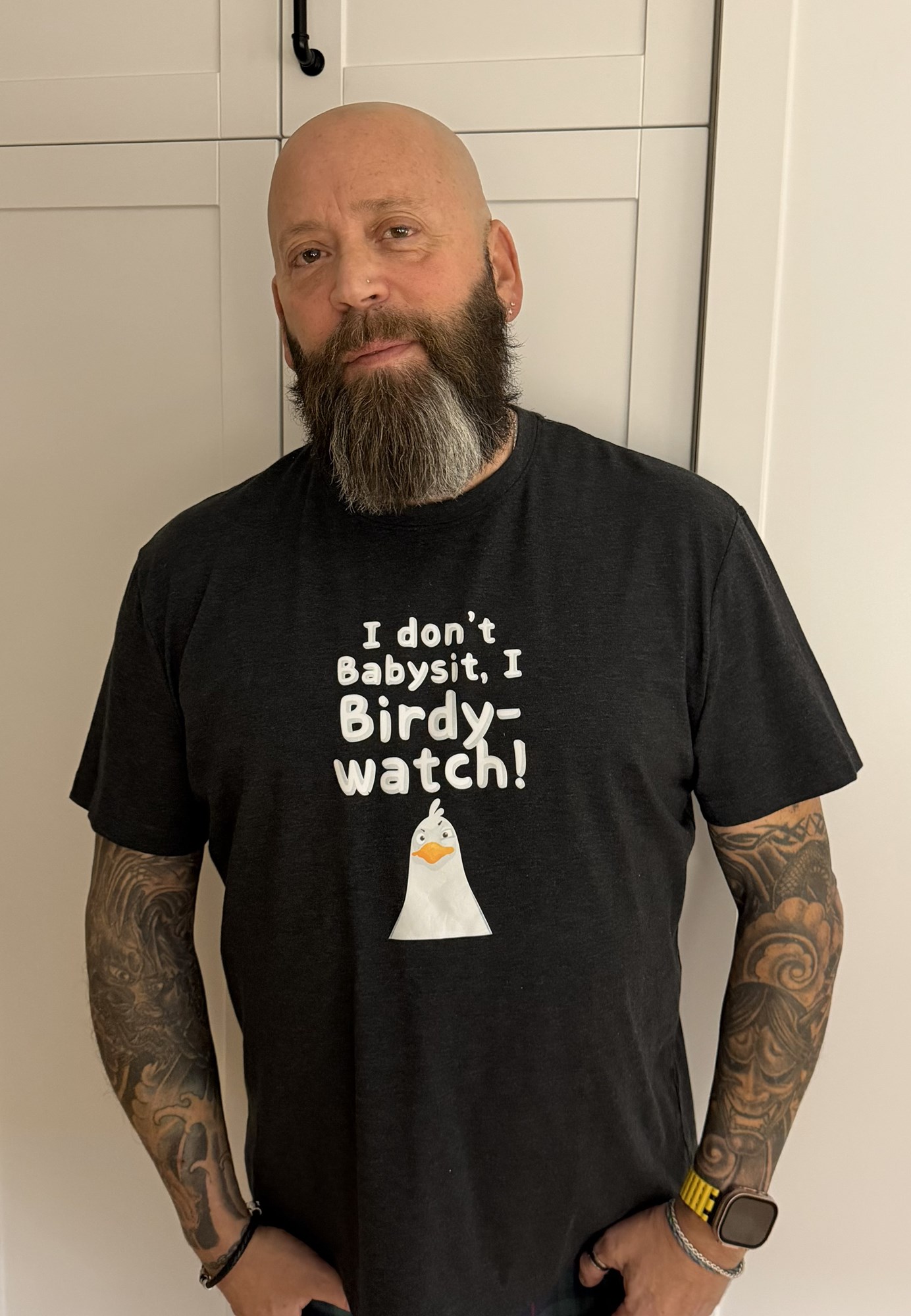 Patron wearing a T-shirt print with the Roland and Cricut Heat Press