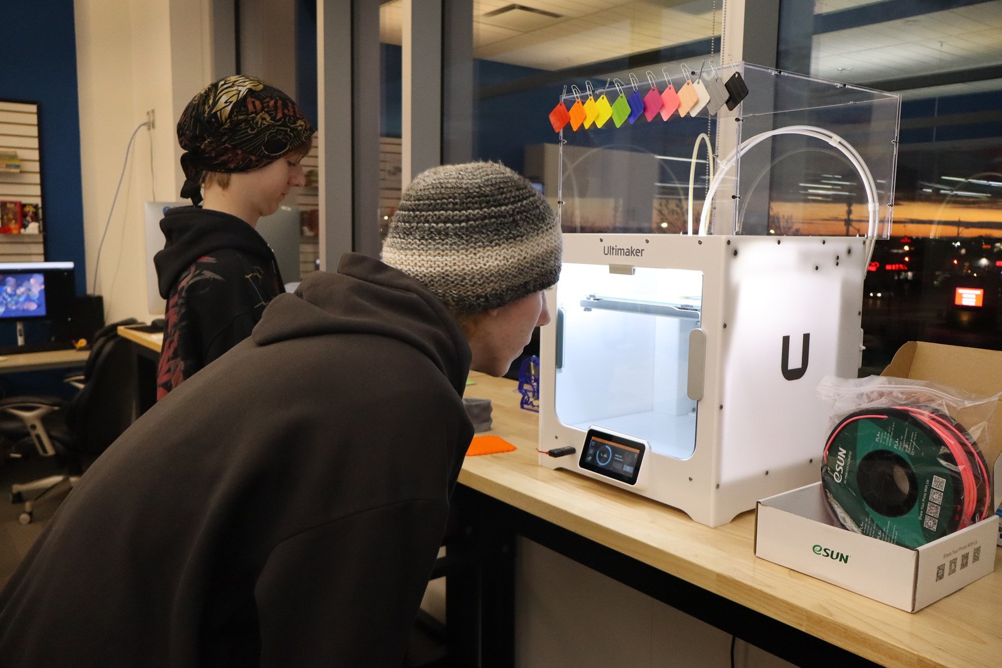 Teen looking into the 3D printer