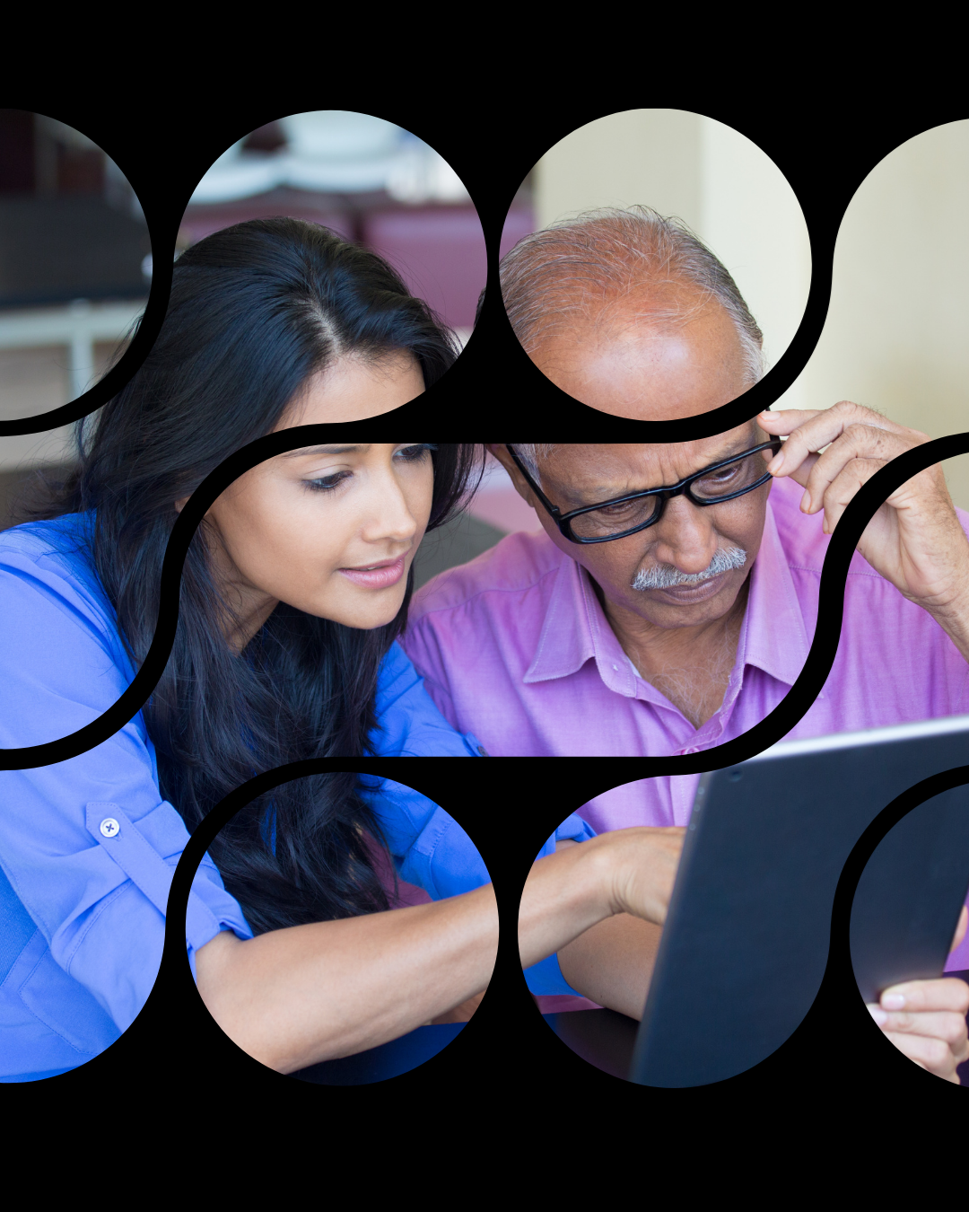 Woman helping an older man with technology. 