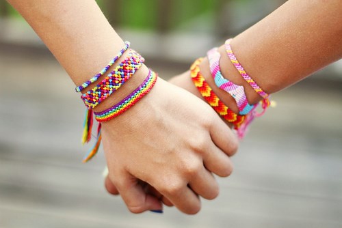 Holding hands wearing bracelets