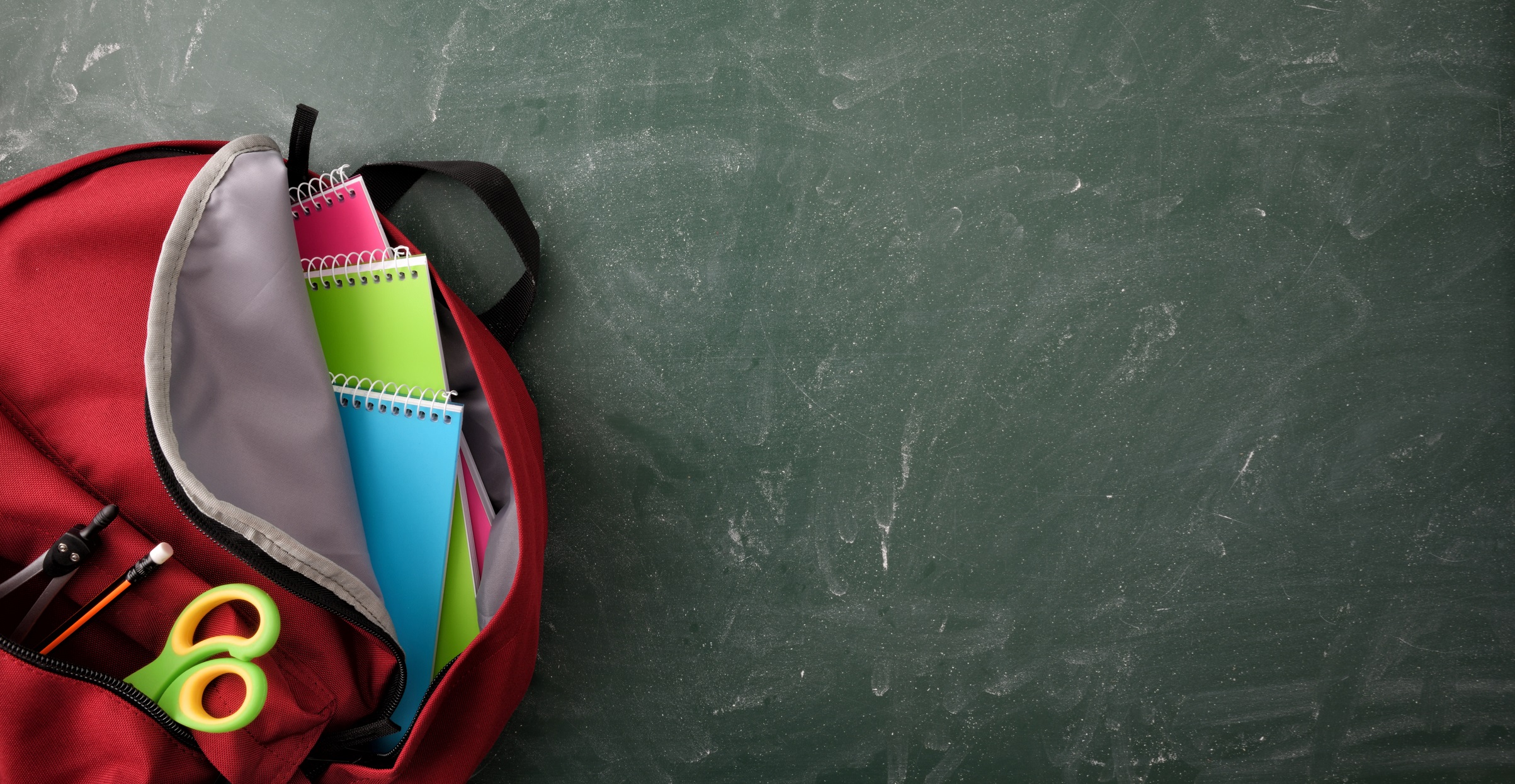 School Backpack on Chalkboard Background