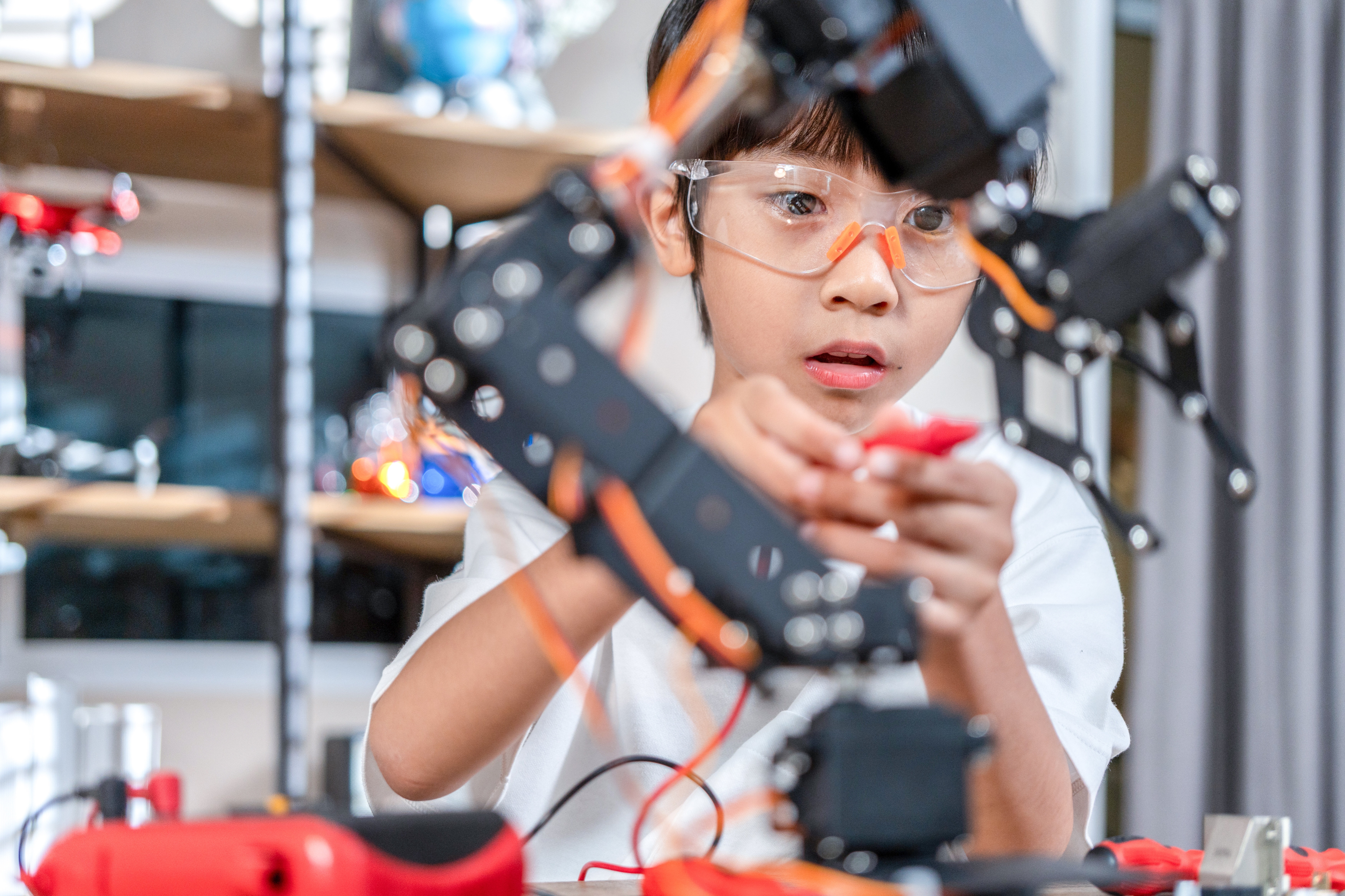 Boy Constructing Toy with Electric Gears