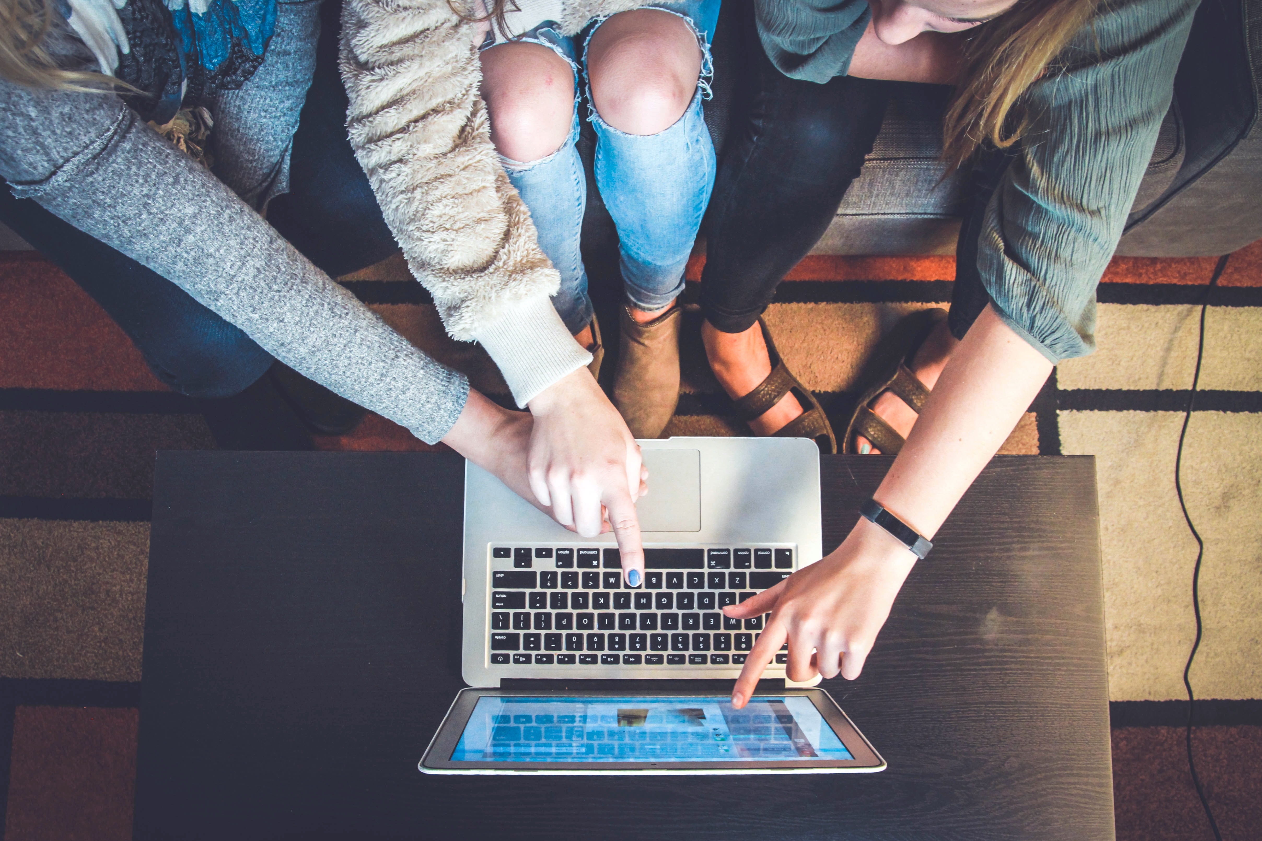 Teens looking at a laptop