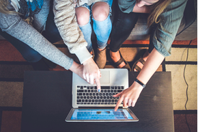 Teens looking at a laptop