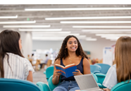 A Group Of Young Women Discussing Assignment In Study Session